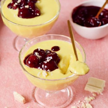 2 Gläser Vanillepudding mit Kirschkompott und Löffel