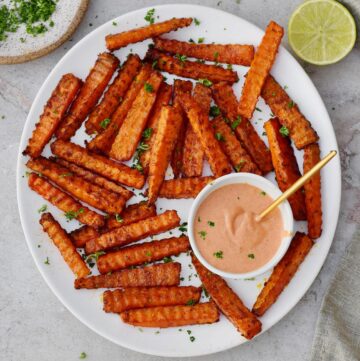 Carrot fries with pin dip on white plate
