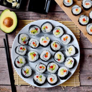 veganes Sushi auf weißem Teller von oben