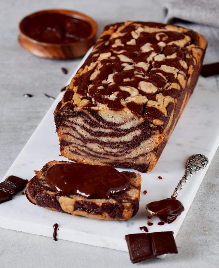 marbled banana bread loaf with chocolate spread on slice