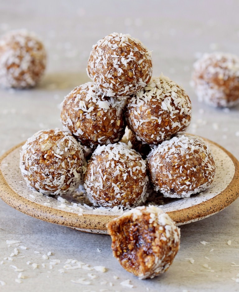 pyramide of energy balls on small plate coated with desiccated coconut