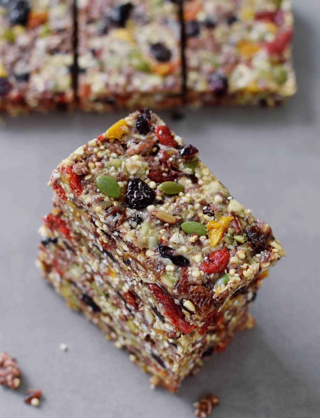 Stack of no-bake granola bars with dried fruit and seeds