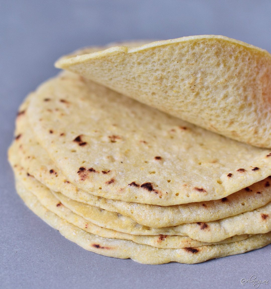 Stack of homemade tortillas with the top one lifted