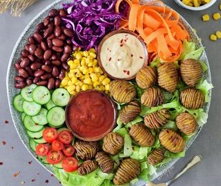This healthy vegan lunch bowl with Hasselback potatoes is filling, easy to make and delicious. The buddha bowl is rich in plant-based protein, gluten-free and grain-free. Two easy and tasty sauce recipes included