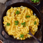 Vegan Mac and Cheese in a black skillet with broccoli