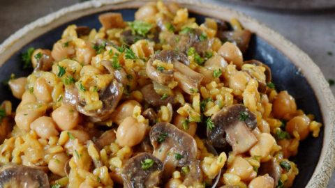 vegan mushroom risotto in a black bowl