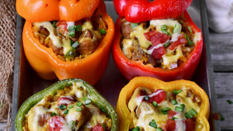 4 vegan stuffed peppers on baking sheet