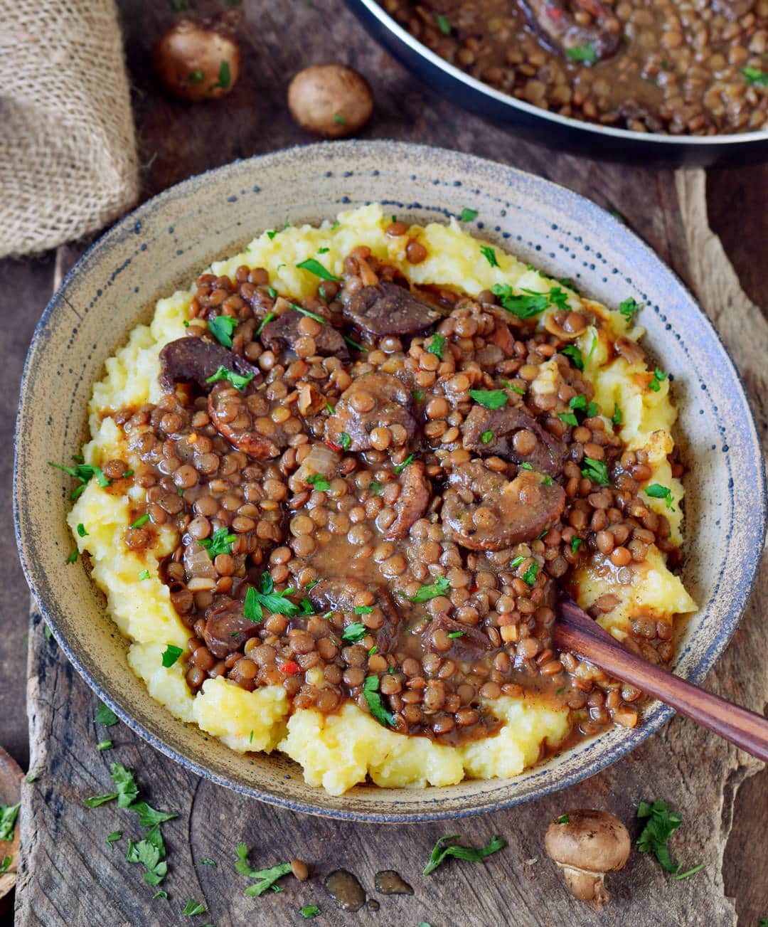 Easy lentil stew with mashed potatoes and mushrooms in a bowl.