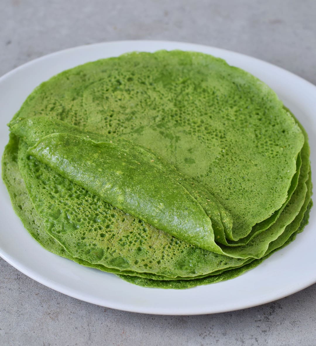 Spinach tortilla stack on a white plate