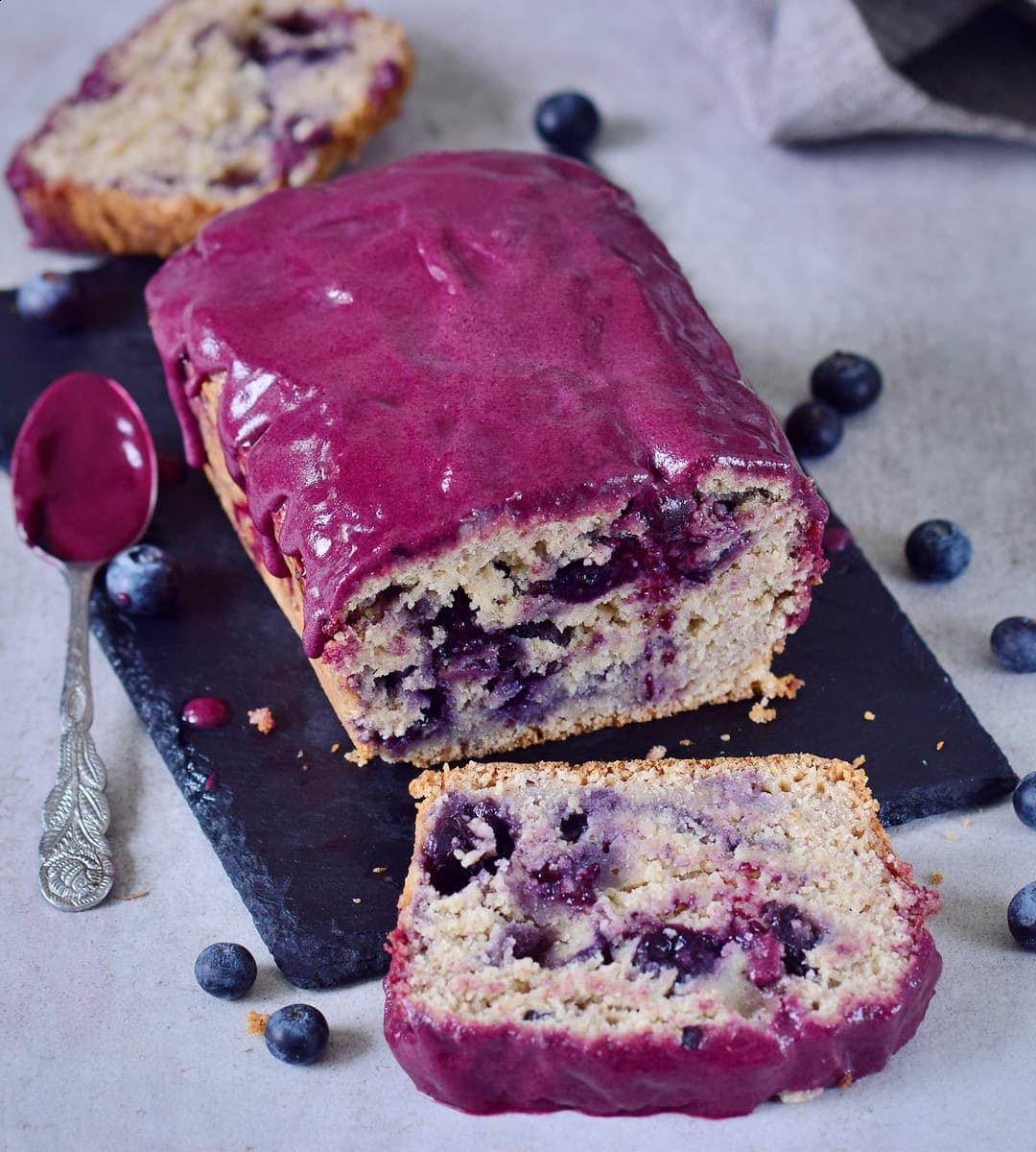 sliced loaf with blueberries and purple frosting
