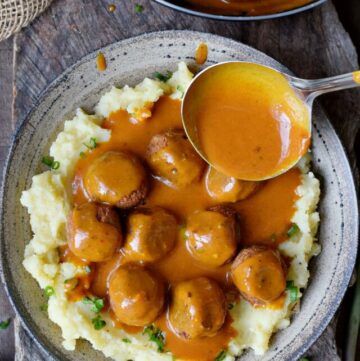 cropped-Vegan-meatballs-with-hearty-gravy-in-a-ladle-over-mashed-potatoes.jpg