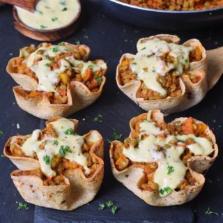 4 homemade easy taco cups with lentils peppers tomatoes and vegan cheese sauce