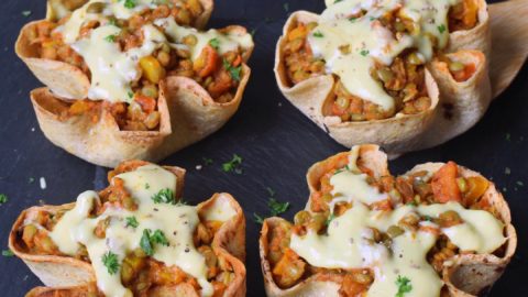 4 homemade easy taco cups with lentils peppers tomatoes and vegan cheese sauce