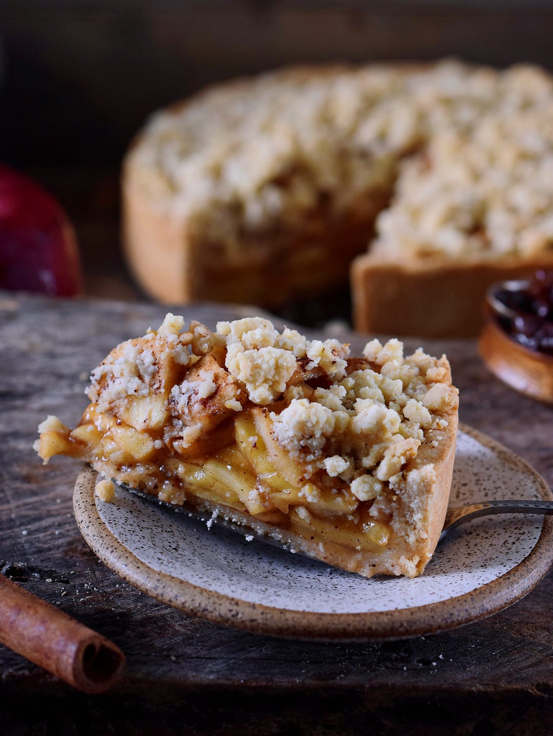 A piece of vegan apple pie with streusel and cinnamon
