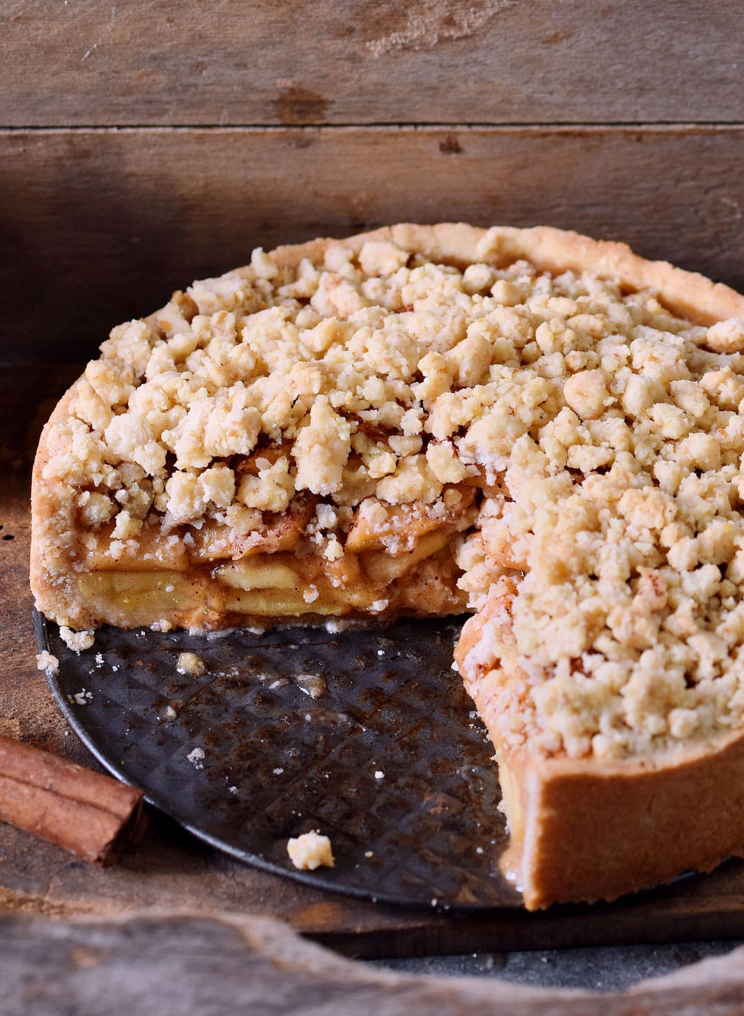 Apple crumble cake on a baking dish cut into