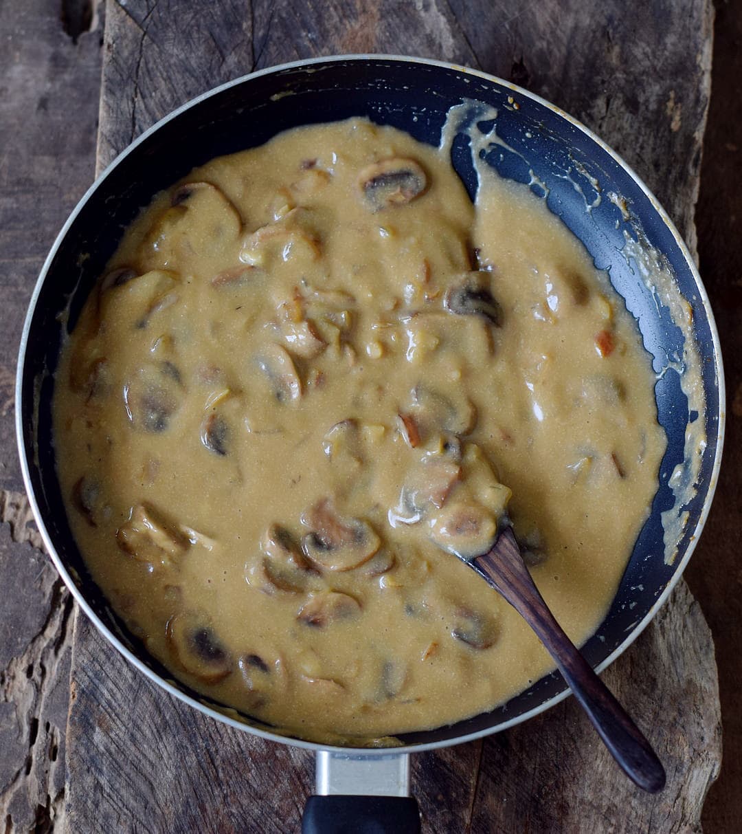 creamy dairy free brown sauce with mushrooms in a pan