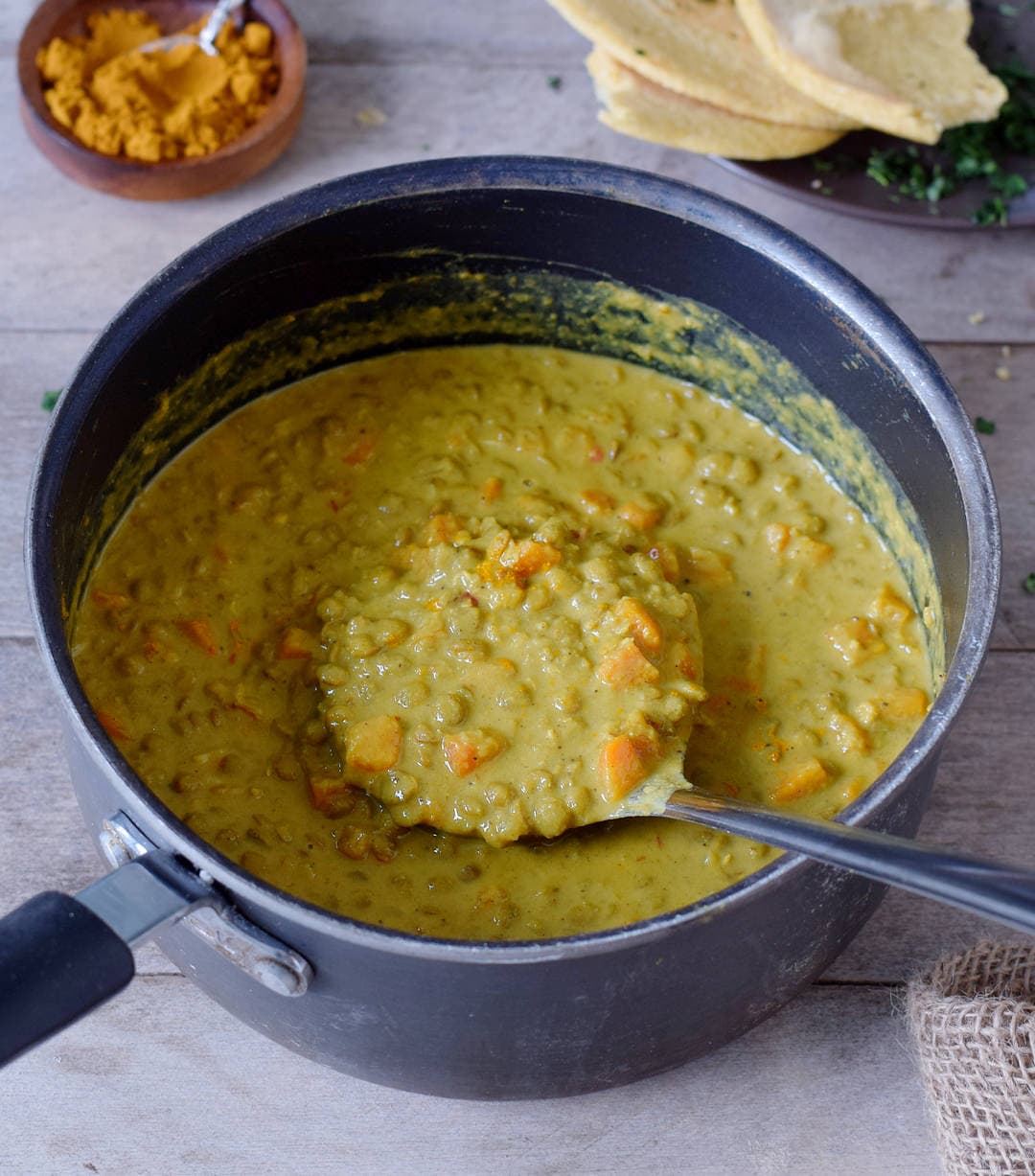 one pot lentil dal with carrots in a pot with a ladle
