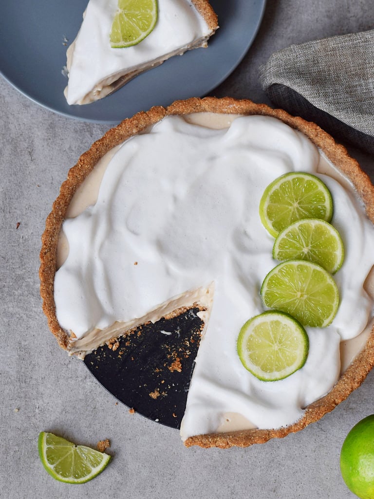 vegan key lime pie with a slice in the background