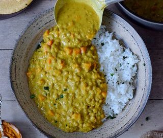 vegan lentil dal with carrots and rice on a plate