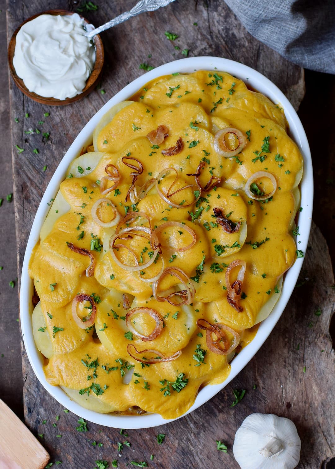 potatoes au gratin in a round baking dish with cream cheese