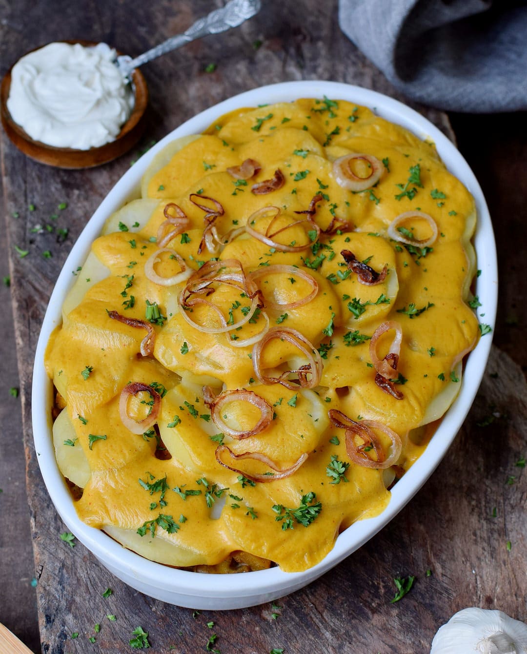vegan potato bake recipe in a round baking dish with cream cheese