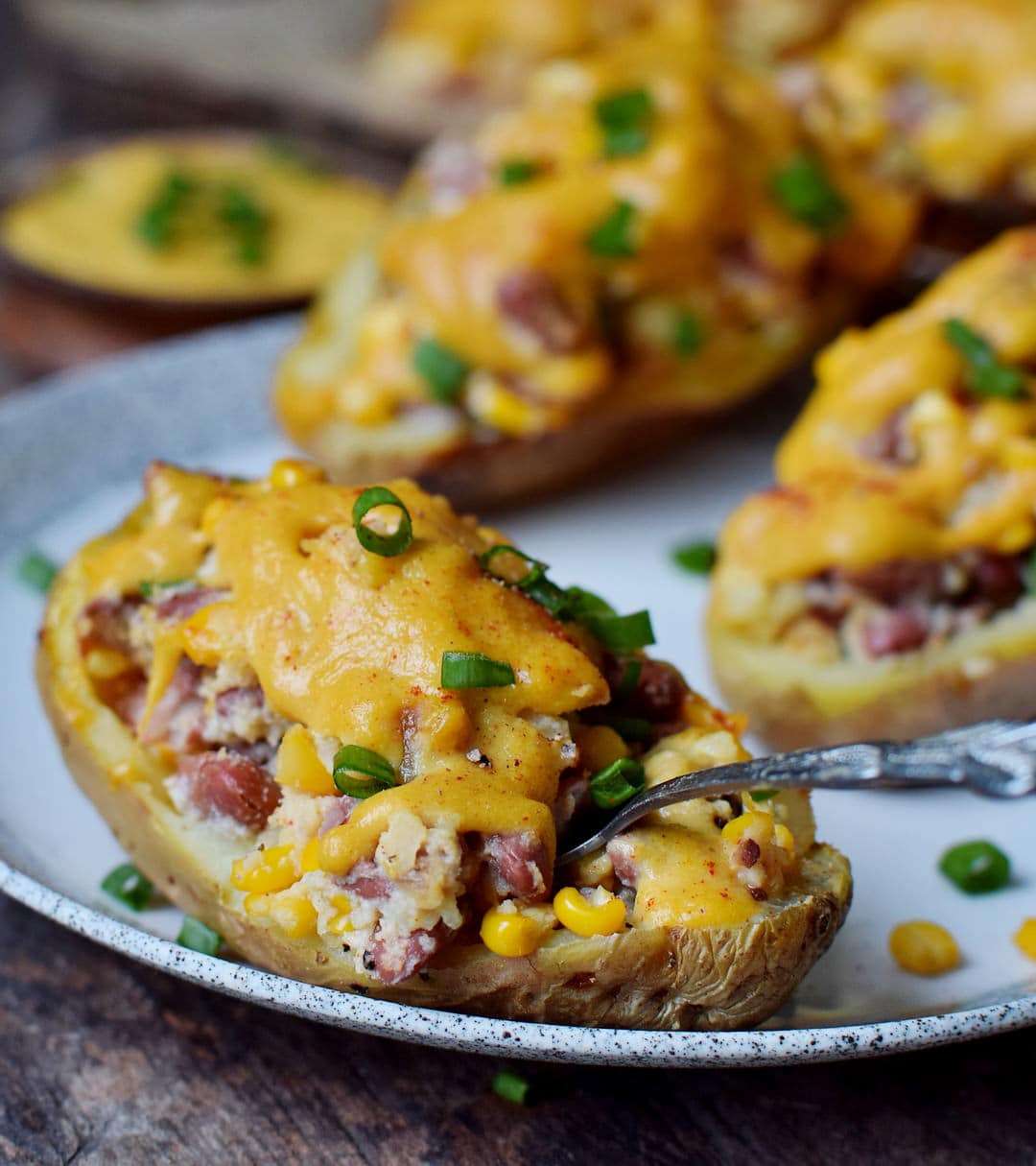 close-up of gluten-free stuffed potato skins with vegan cheese on a plate