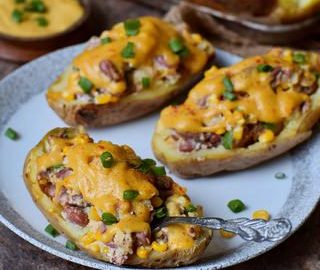 gluten-free stuffed potato skins with vegan cheese sauce on a plate