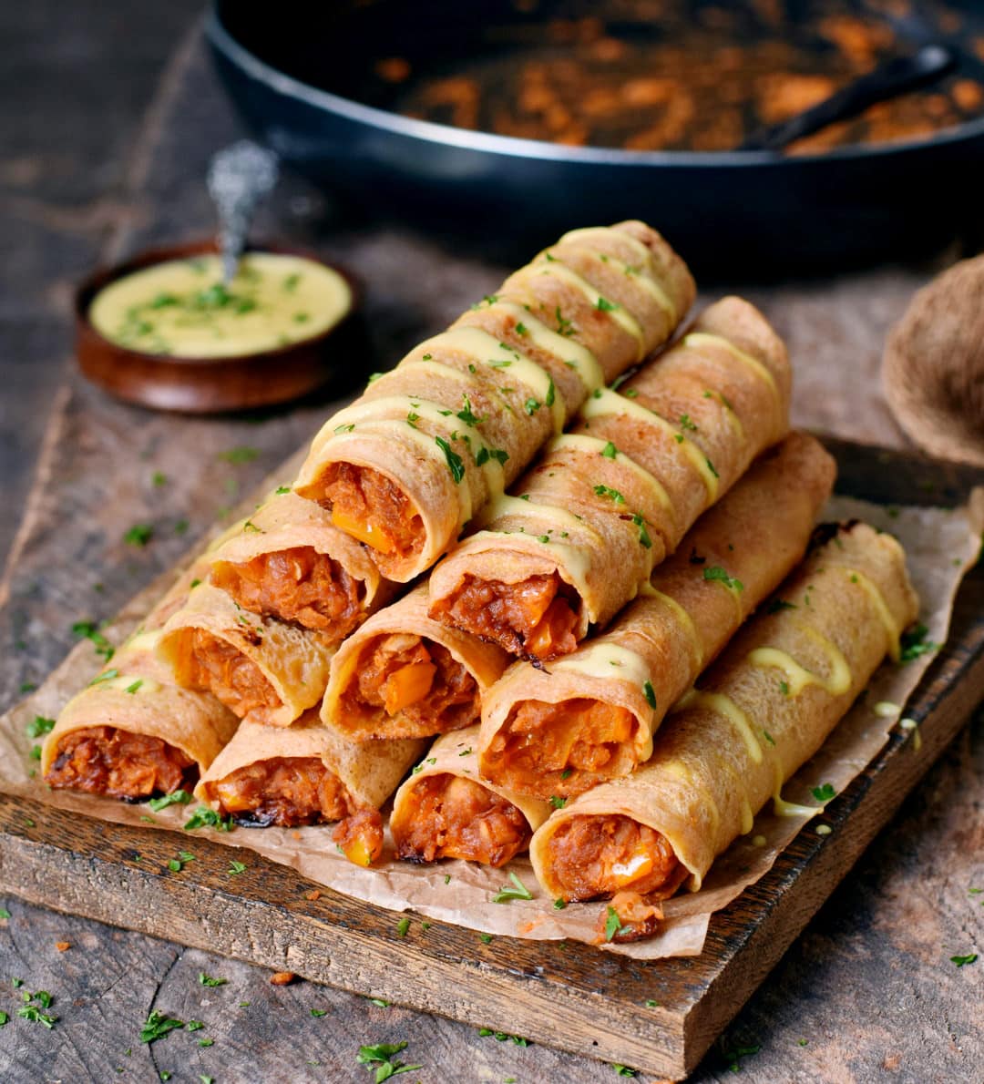 Gluten-free Buffalo chickpea taquitos with vegan cheese drizzle