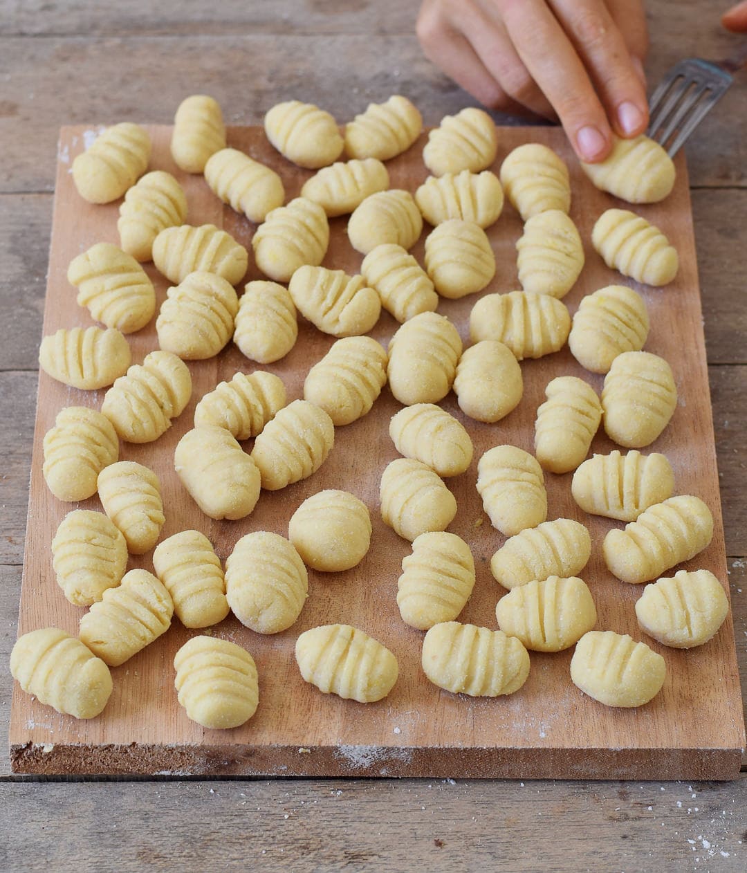 Homemade gluten-free vegan gnocchi before cooking on a cutting board