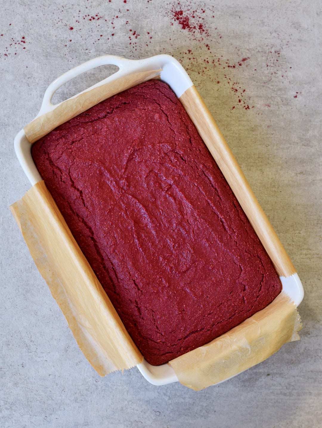 Baked cake in a white baking dish for red velvet bars elavegan.com