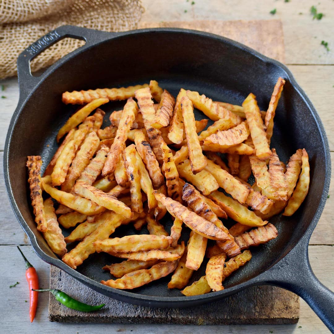 oven baked fries in a skillet for vegan chili cheese fries