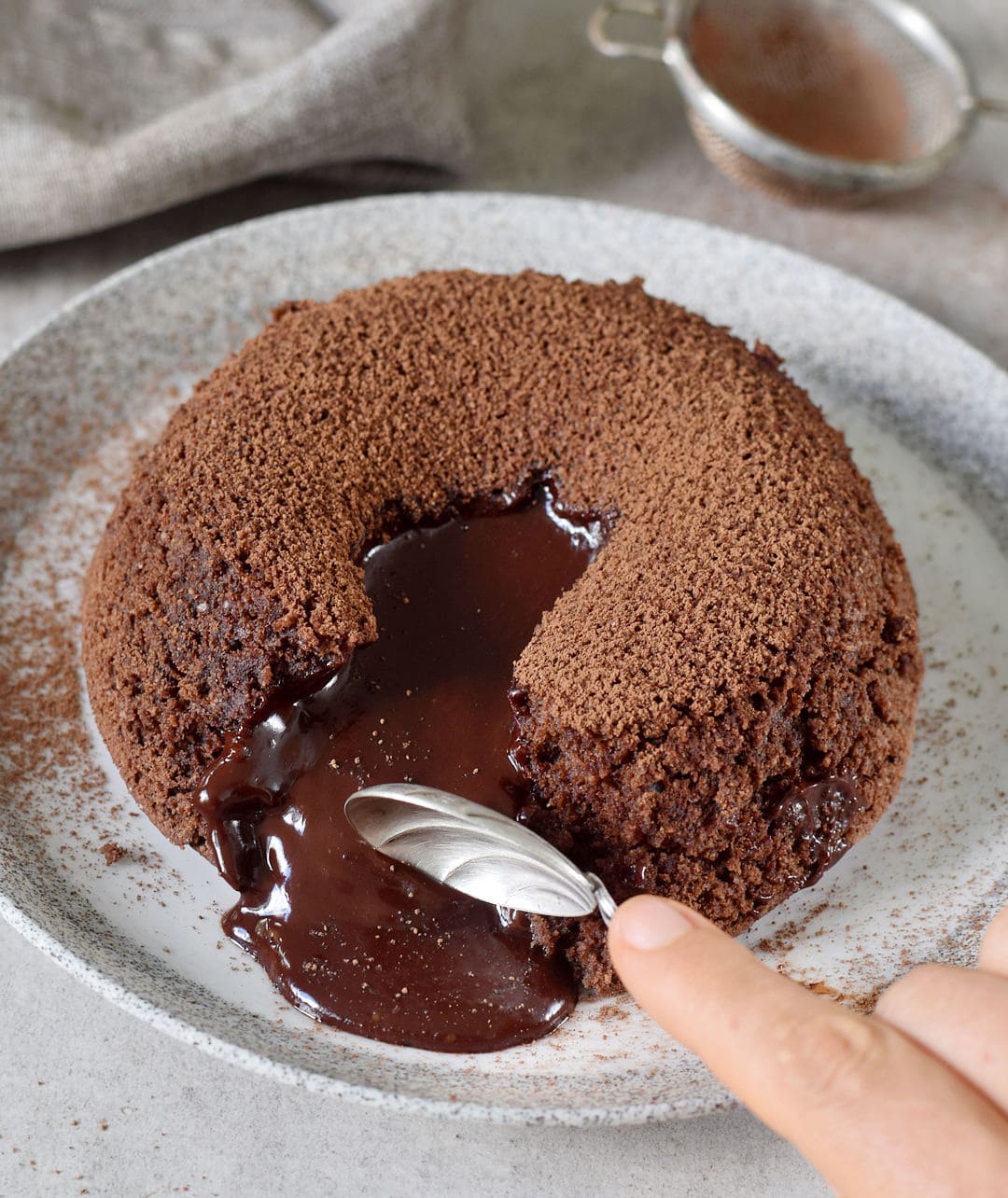 Eating dairy-free lava cake with chocolate center