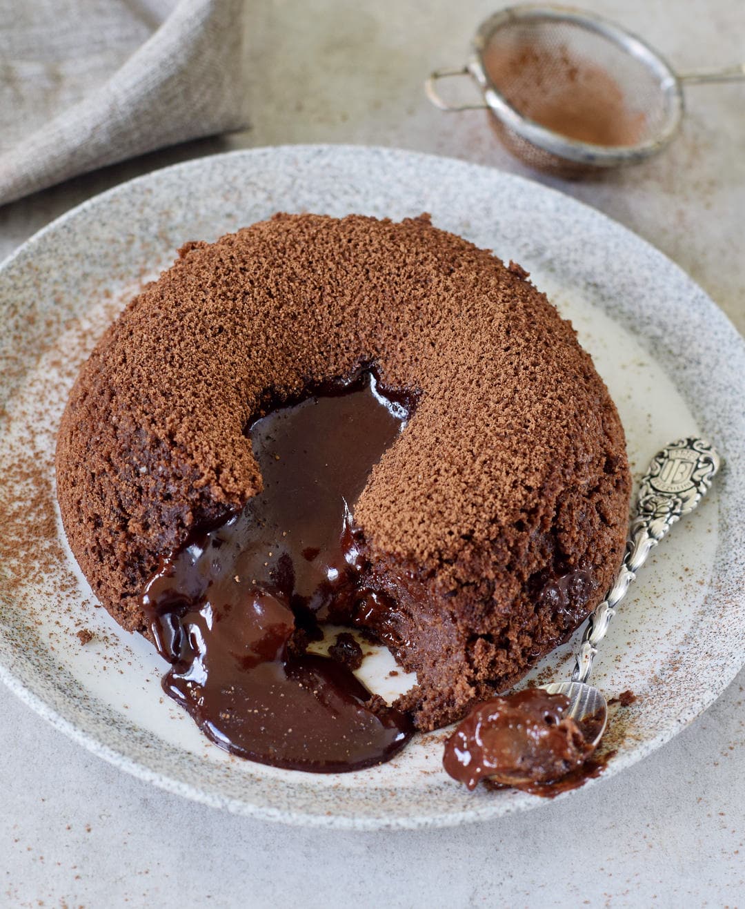 Molten chocolate cake with spoon on plate