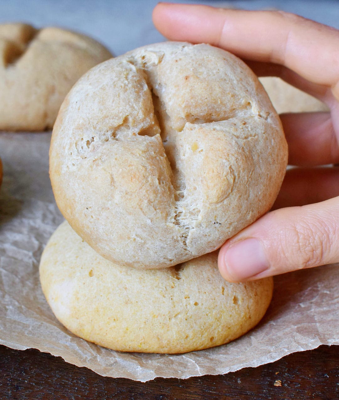 holding soft vegan gluten-free buns (bread rolls)