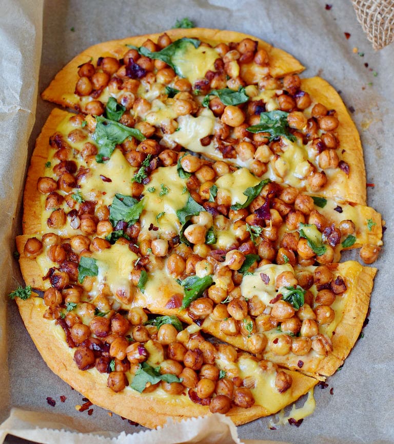Pizza (Teig aus Süßkartoffeln) belegt mit Kichererbsen Spinat und veganem Käse