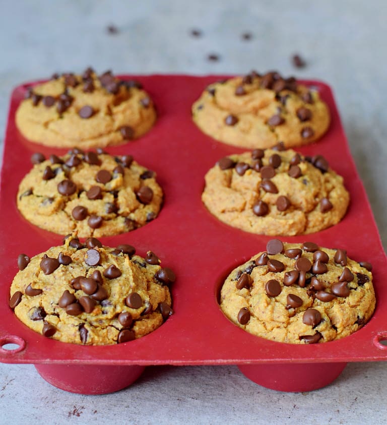 vegan chocolate chip sweet potato muffins in a red silicone mold