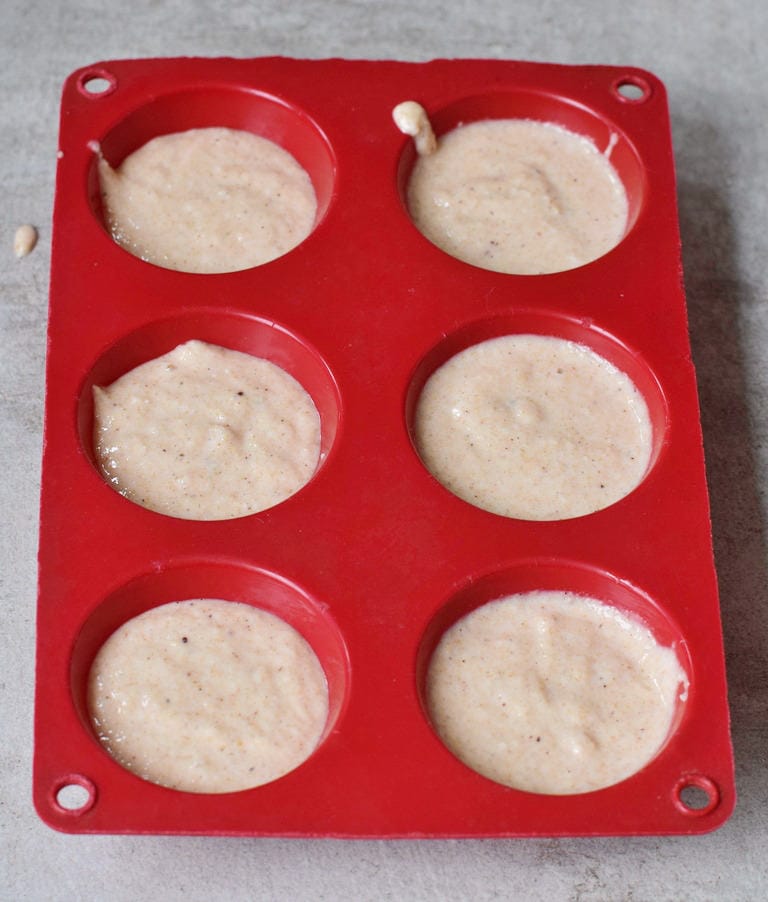 batter in red silicone muffin mold