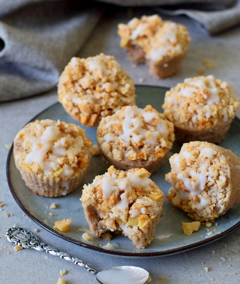 apple crumble muffins on a plate with sugar-free icing