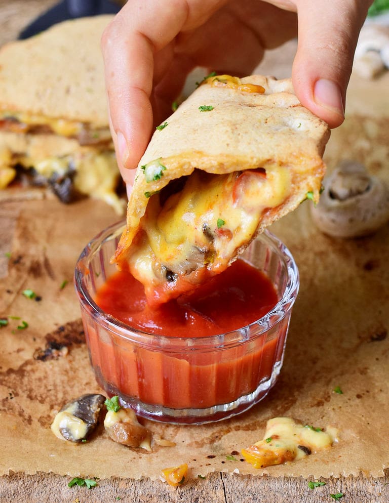 vegan calzone with mushrooms peppers tomato sauce and plant-based cheese cheese