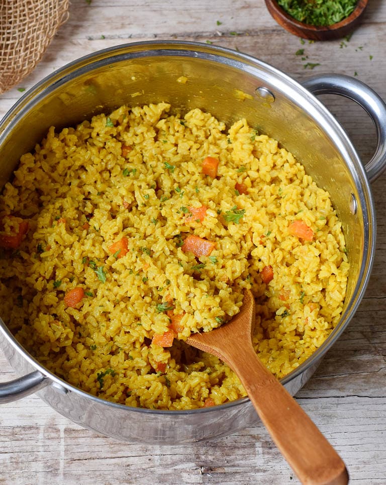 Turmeric coconut rice with veggies in a large pot