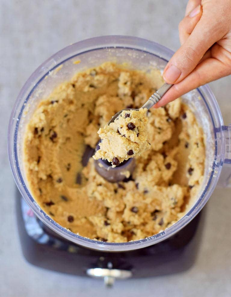 dough with chickpeas and chocolate chips on spoon