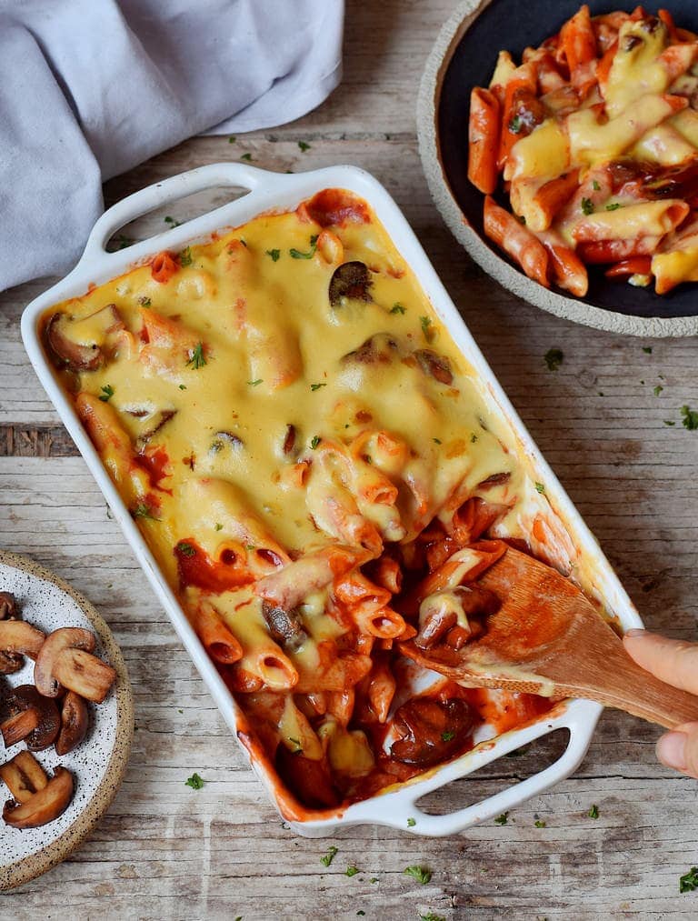 Pasta bake with mushrooms in a white baking dish
