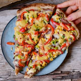 Pizza with peppers corn refried beans and vegan cheese
