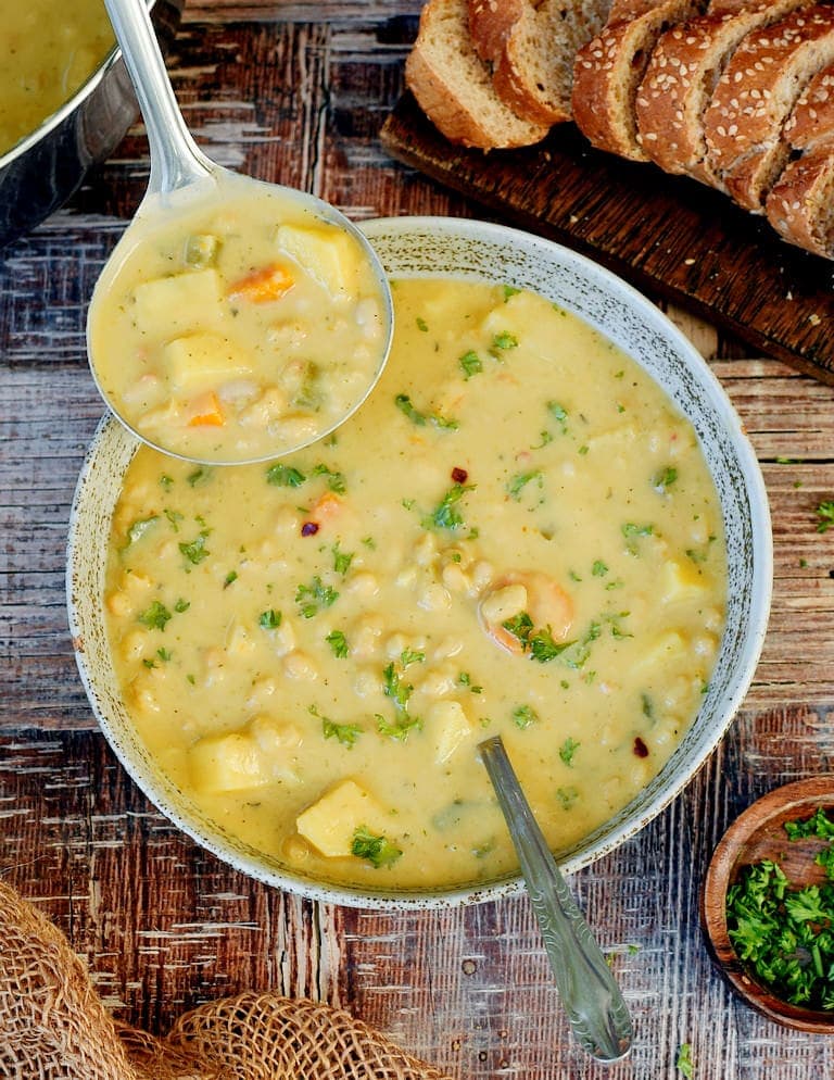 Corn chowder with a ladle in a bowl