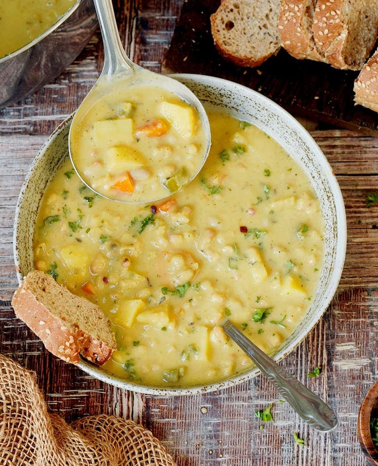 Creamy vegan white bean soup with bread in a bowl