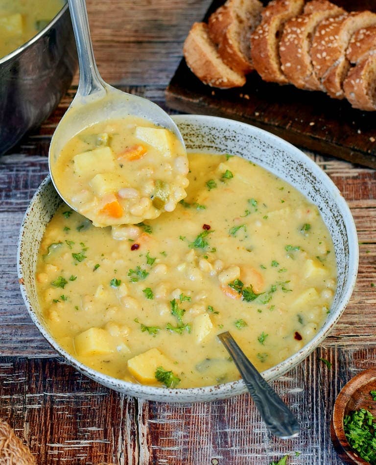 Creamy white bean soup with bread in a bowl