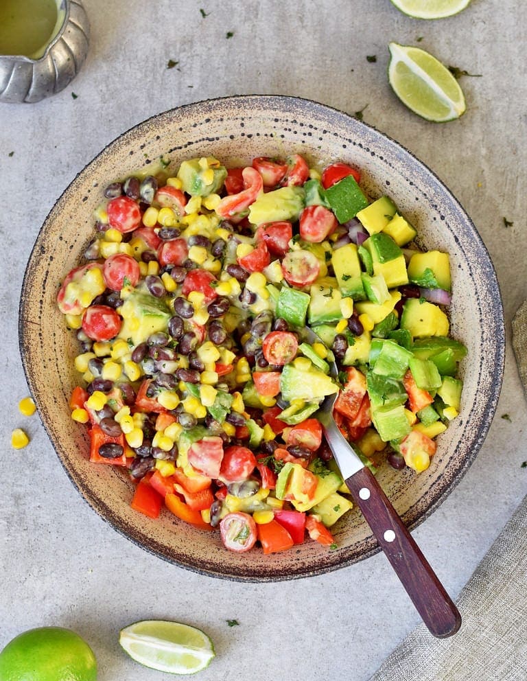 Healthy Mexican avocado salad with corn, black beans, oil-free dressing
