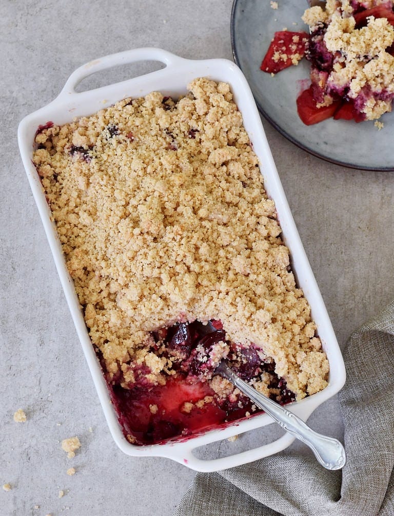 plum and apple crumble in a baking dish