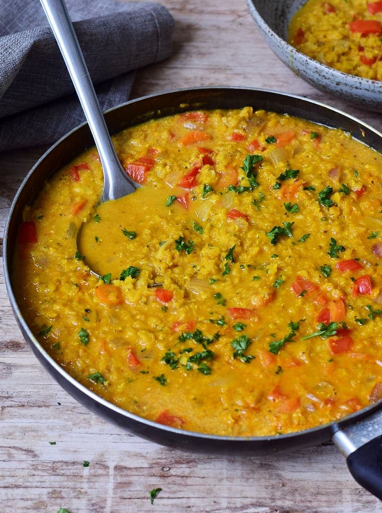 Red Lentil Dal in a pan with ladle