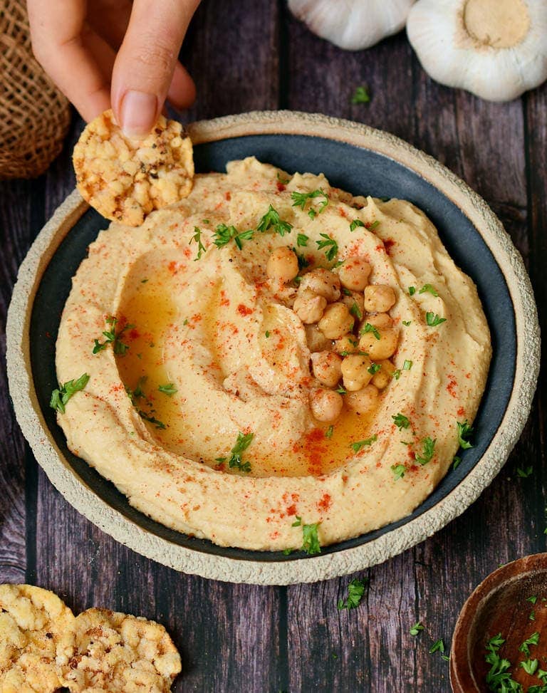 creamy oil-free chickpea hummus in a bowl with crackers